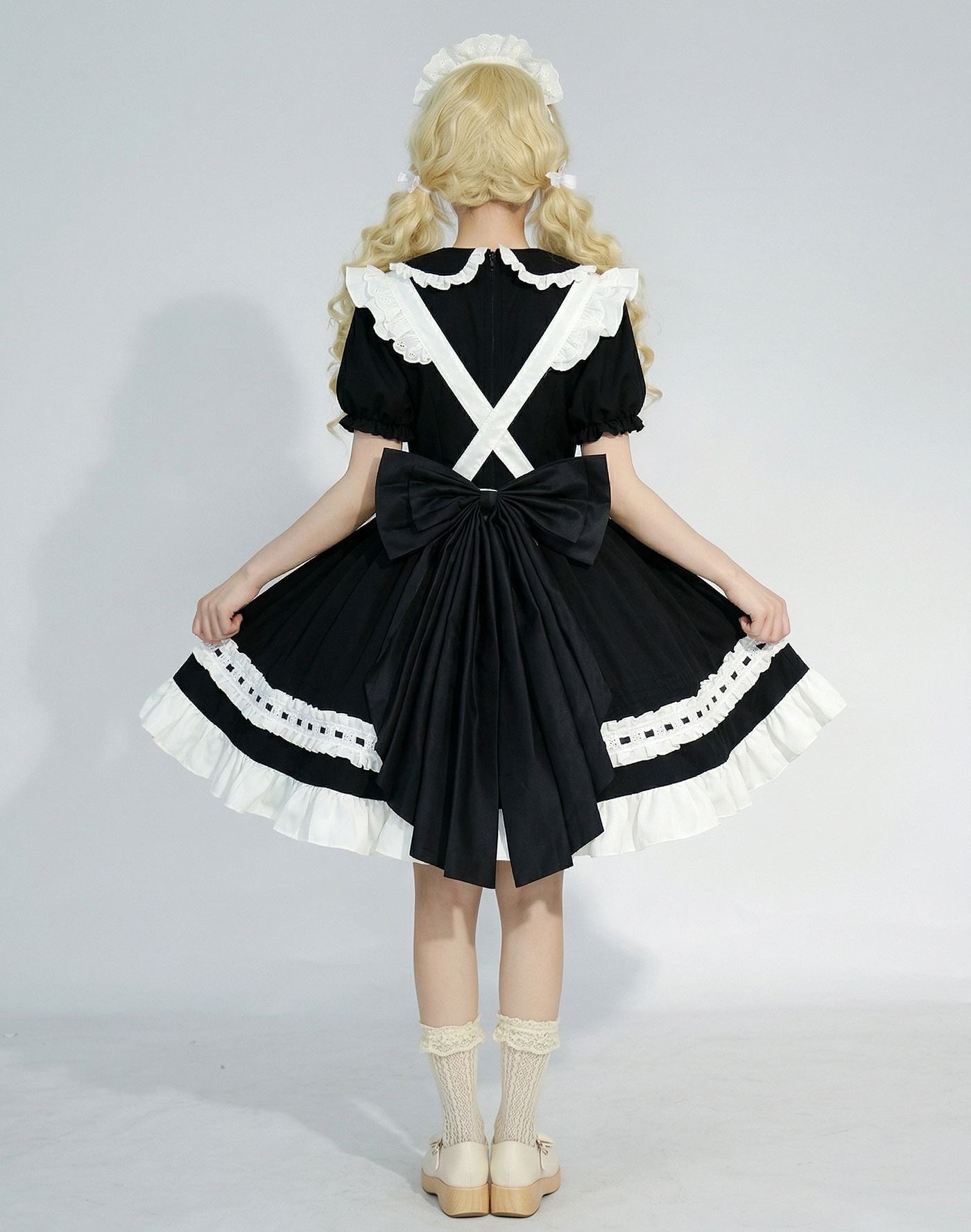 female model showing back big bow of maid cosplay dress